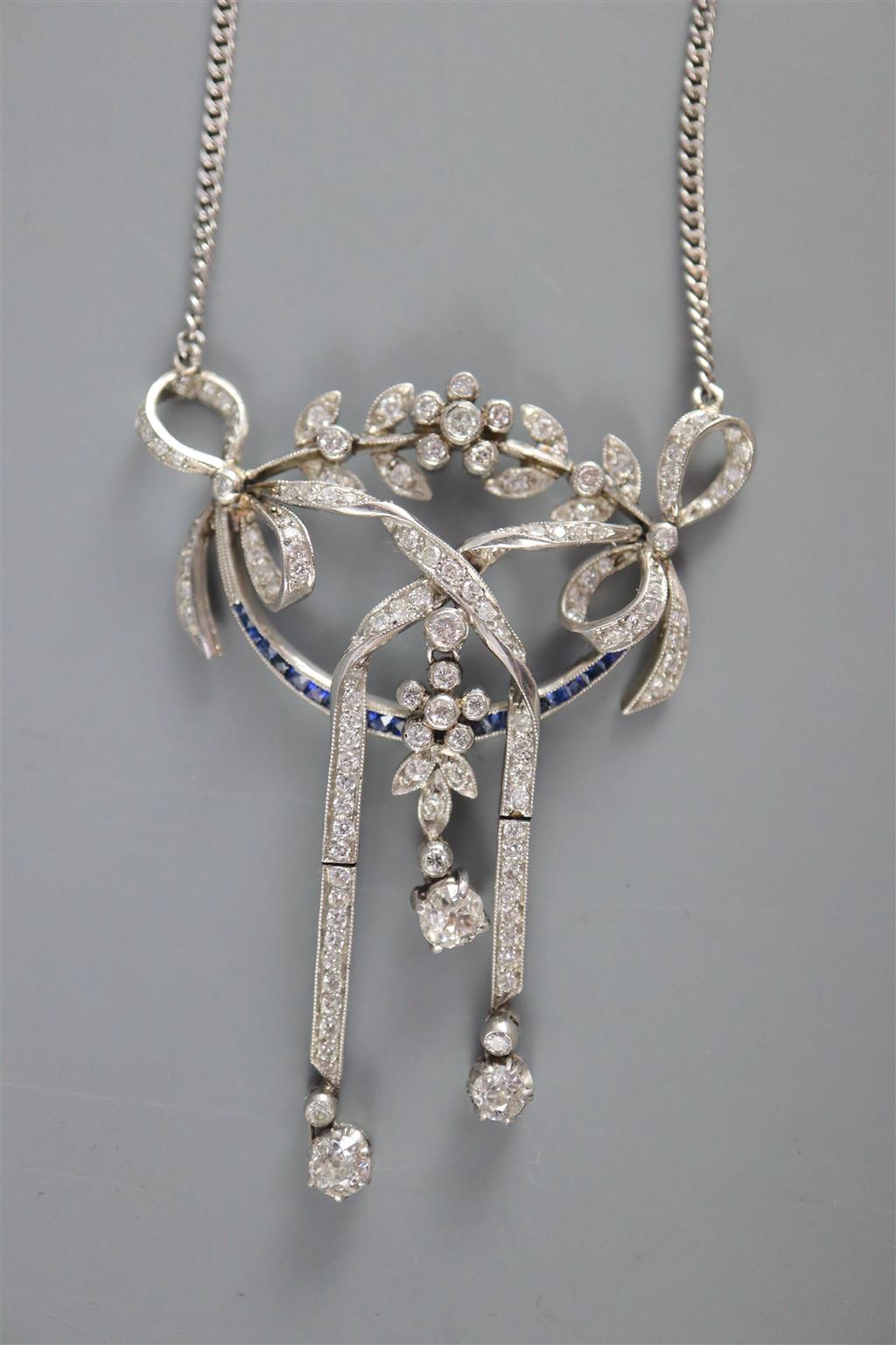 An early 20th century platinum, sapphire and diamond set articulated openwork drop pendant necklace,